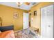 Cozy bedroom features a ceiling fan and closet for storage with an area rug on the floor at 5925 18Th Ne St, St Petersburg, FL 33703