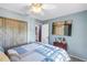 Cozy bedroom with a large bed, wood details, and an ensuite bathroom at 5925 18Th Ne St, St Petersburg, FL 33703