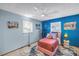 Bright bedroom with a stylish bed and unique flamingo themed wall art at 5925 18Th Ne St, St Petersburg, FL 33703