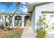 Inviting home entrance with an arched, covered porch, decorative accents, and a well-maintained walkway at 5925 18Th Ne St, St Petersburg, FL 33703