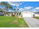 Charming single-story home with a two-car garage, lush lawn, and mature trees offering shade at 5925 18Th Ne St, St Petersburg, FL 33703