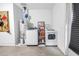 Laundry room equipped with a washer, dryer, and shelving for storage with painted walls at 5925 18Th Ne St, St Petersburg, FL 33703