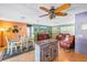 Open-concept living room with hardwood floors, eclectic decor, and a unique fan at 5925 18Th Ne St, St Petersburg, FL 33703