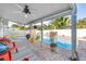 Relaxing covered patio with ceiling fan and view of the sparkling pool and lush landscaping at 5925 18Th Ne St, St Petersburg, FL 33703