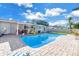 Relaxing backyard with a sparkling blue pool and brick-paved patio, perfect for outdoor living and entertaining at 5925 18Th Ne St, St Petersburg, FL 33703