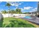 Lush backyard featuring a sparkling pool, privacy fence, and tropical landscaping for the ultimate retreat at 5925 18Th Ne St, St Petersburg, FL 33703