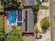 Aerial view of a home featuring a large swimming pool, solar panels, and well-maintained landscaping at 5968 46Th N Ave, Kenneth City, FL 33709