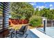 Cozy backyard with a lounge chair, side table, lush green trees, and a red fence at 5968 46Th N Ave, Kenneth City, FL 33709