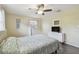 Bedroom featuring laminate floors, ceiling fan, white dresser and window at 5968 46Th N Ave, Kenneth City, FL 33709