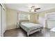 Comfortable bedroom with laminate floors, ceiling fan, and natural light at 5968 46Th N Ave, Kenneth City, FL 33709