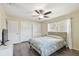 Bedroom with laminate floors, ceiling fan, window, and white double closet at 5968 46Th N Ave, Kenneth City, FL 33709