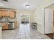 Open kitchen flowing into a living room area with stainless steel appliances and light wood cabinetry at 5968 46Th N Ave, Kenneth City, FL 33709