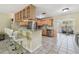 Modern kitchen with an open layout, stainless steel appliances, a marble breakfast bar and wood cabinets at 5968 46Th N Ave, Kenneth City, FL 33709