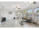 Sunroom features hardwood flooring, multiple windows and fans to let in the natural light and airflow at 5968 46Th N Ave, Kenneth City, FL 33709