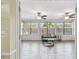 Sunroom features hardwood flooring, multiple windows and fans to let in the natural light and airflow at 5968 46Th N Ave, Kenneth City, FL 33709