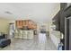 Open concept living space with breakfast bar, tile flooring, and ample seating at 5968 46Th N Ave, Kenneth City, FL 33709
