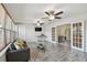 Sunroom features hardwood flooring, multiple windows and fans to let in the natural light and airflow at 5968 46Th N Ave, Kenneth City, FL 33709