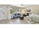 Bright living room with tiled floors, comfortable couches, lots of natural light, and open to kitchen area at 5968 46Th N Ave, Kenneth City, FL 33709