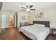 Bright main bedroom features a ceiling fan, wood floors, and ensuite bathroom access at 5968 46Th N Ave, Kenneth City, FL 33709