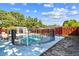 Fenced in swimming pool surrounded by a white concrete patio with lounge chairs at 5968 46Th N Ave, Kenneth City, FL 33709