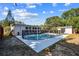 Backyard swimming pool with lounge chairs, storage shed, and plenty of trees at 5968 46Th N Ave, Kenneth City, FL 33709