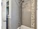 Bathroom shower with gray subway tile, mosaic accent, and updated fixtures at 5968 46Th N Ave, Kenneth City, FL 33709