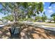 This property boasts mature trees and landscaping, just steps from a shaded park bench at 5968 46Th N Ave, Kenneth City, FL 33709