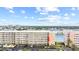 Aerial view of a beige multi-story building with a red arrow pointing to the unit at 6075 Shore S Blvd # 215, Gulfport, FL 33707