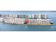 Aerial view of multi-story buildings surrounded by water, with a red arrow pointing to the unit at 6075 Shore S Blvd # 215, Gulfport, FL 33707
