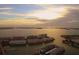 Breathtaking aerial view of waterfront condos with stunning sunset backdrop, showcasing the prime coastal location at 6075 Shore S Blvd # 215, Gulfport, FL 33707