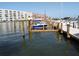 Boat dock with boat, surrounded by water and condos, perfect for waterfront living and enjoying the outdoors at 6075 Shore S Blvd # 215, Gulfport, FL 33707