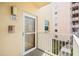 Condo front door entrance with glass window and outdoor balcony at 6075 Shore S Blvd # 215, Gulfport, FL 33707