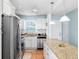 Bright kitchen featuring stainless steel appliances and a large island at 6075 Shore S Blvd # 215, Gulfport, FL 33707