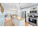 Open-concept kitchen with an island, stainless steel appliances, and adjacent dining area at 6075 Shore S Blvd # 215, Gulfport, FL 33707