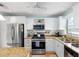 Well-lit kitchen with stainless appliances and granite countertops at 6075 Shore S Blvd # 215, Gulfport, FL 33707