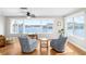 Bright living room with water views from large windows and blue patterned chairs at 6075 Shore S Blvd # 215, Gulfport, FL 33707