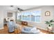 Bright living room featuring beautiful water views from large windows, light walls, and hardwood floors at 6075 Shore S Blvd # 215, Gulfport, FL 33707