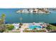 Community pool with tiki hut umbrellas and lounge chairs overlooking the bay at 6075 Shore S Blvd # 215, Gulfport, FL 33707