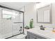 Updated bathroom featuring a tub with subway tile surround, glass door, and modern vanity at 6137 Halifax Dr, New Port Richey, FL 34653