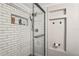 Bathroom shower with white subway tile, glass door, and sleek black hardware at 6137 Halifax Dr, New Port Richey, FL 34653
