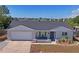 Charming single Gathering home with a brick facade, gray roof, and landscaping at 6137 Halifax Dr, New Port Richey, FL 34653