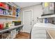 Practical laundry room featuring built-in shelves, countertop space, and laundry appliances at 6137 Halifax Dr, New Port Richey, FL 34653