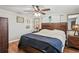 Comfortable bedroom featuring a large bed, wood furniture, ceiling fan, and natural lighting at 6137 Halifax Dr, New Port Richey, FL 34653