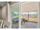 View of a shaded patio with outdoor seating through sliding glass doors at 6137 Halifax Dr, New Port Richey, FL 34653