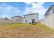 Large backyard includes a swing set, sandbox, privacy fence, and green grass at 6180 Spring Crayfish Ave, New Port Richey, FL 34653
