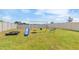 Spacious backyard features a swing set, slide, sandbox and a well-manicured lawn at 6180 Spring Crayfish Ave, New Port Richey, FL 34653