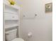 Small bathroom featuring built in shelves, a white toilet, and a towel rack at 6180 Spring Crayfish Ave, New Port Richey, FL 34653