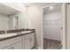 This bathroom features double sinks and a walk-in closet for ample storage at 6180 Spring Crayfish Ave, New Port Richey, FL 34653