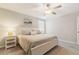 Comfortable bedroom boasts a queen bed, soft gray tones, ceiling fan and bright window at 6180 Spring Crayfish Ave, New Port Richey, FL 34653