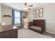 Charming Bedroom with a dark wood crib, soft blue accents, and a ceiling fan at 6180 Spring Crayfish Ave, New Port Richey, FL 34653